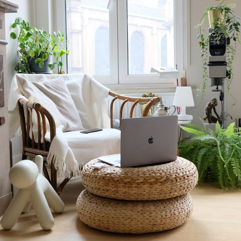 silver macbook on brown woven round table