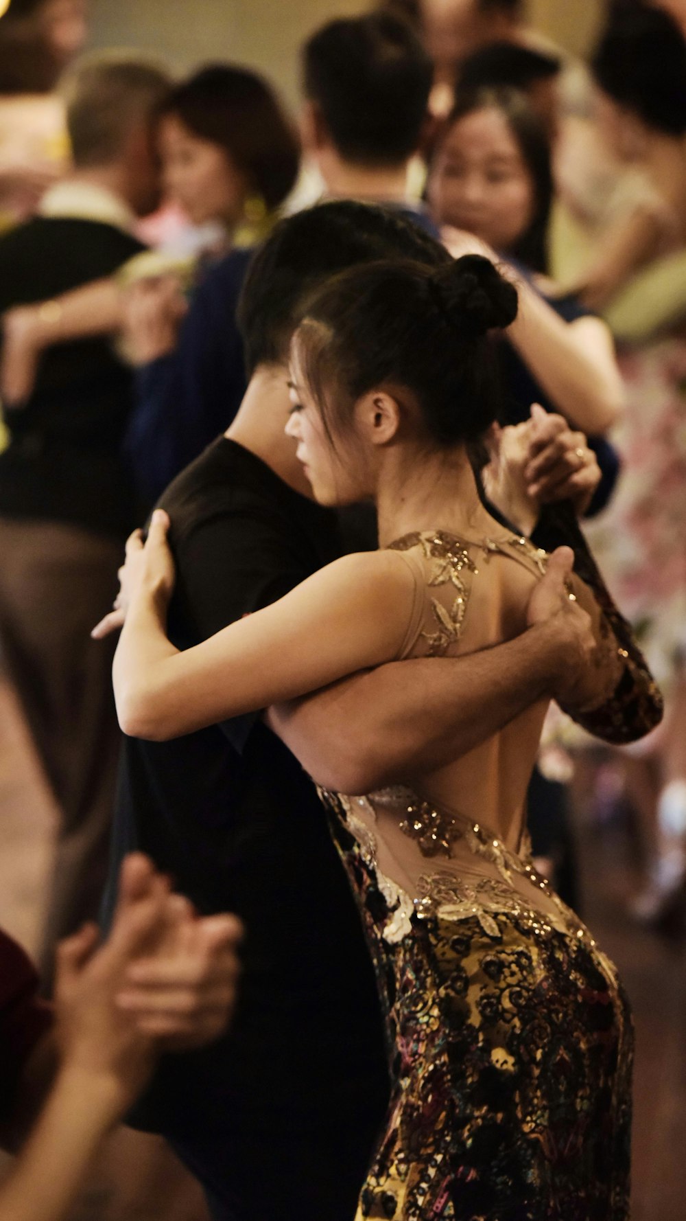 woman in black dress dancing with man in black shirt