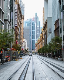 city street with cars and cars parked on the side of the road during daytime