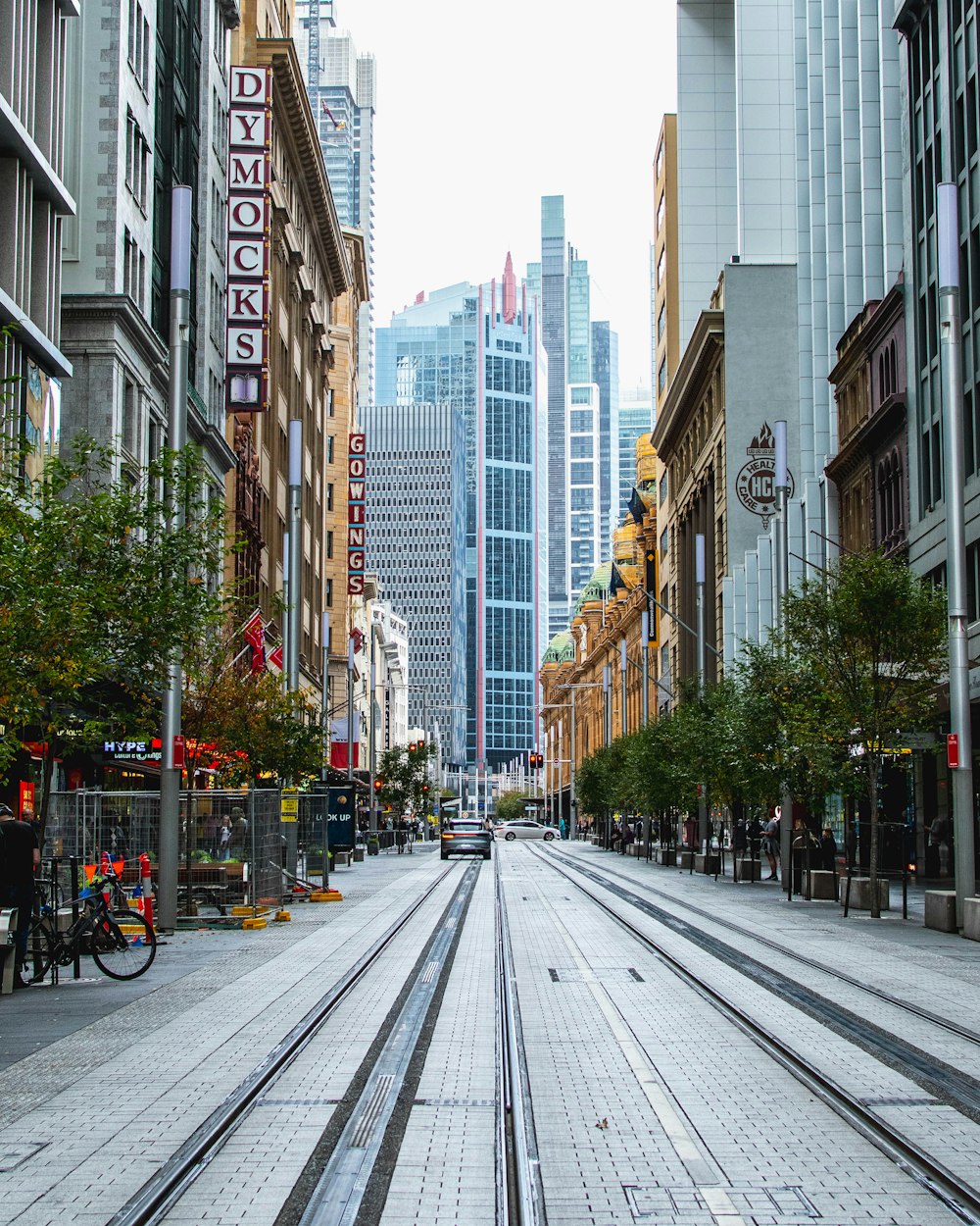 city street with cars and cars parked on the side of the road during daytime