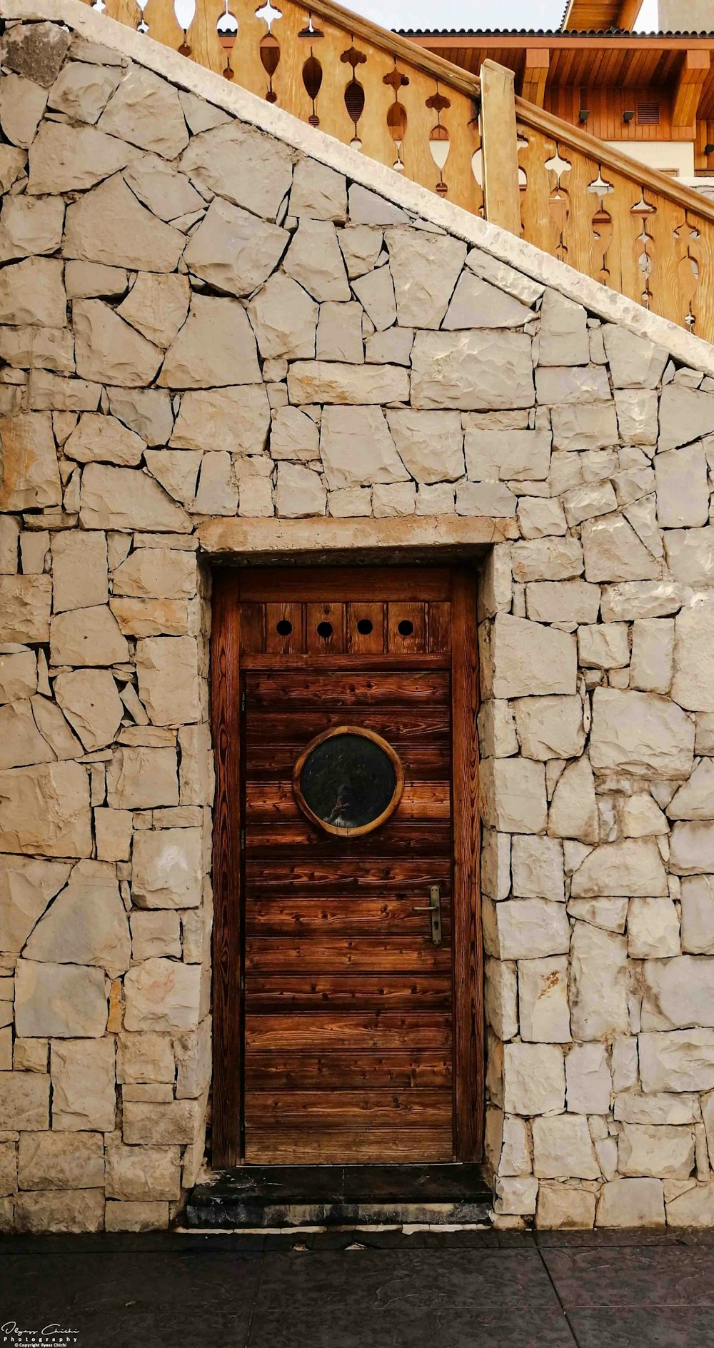 brown wooden door on gray concrete wall