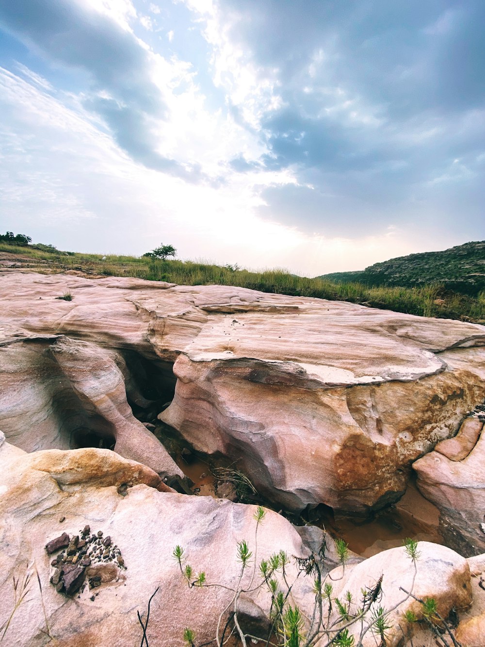 brown rock formation under white clouds during daytime