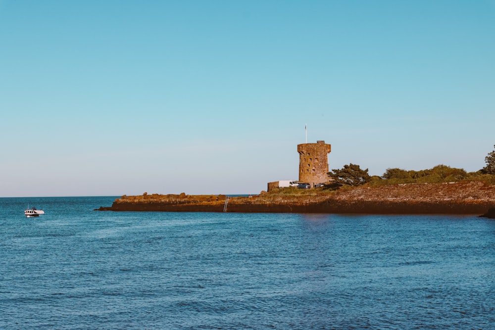 brown concrete building on island surrounded by water during daytime