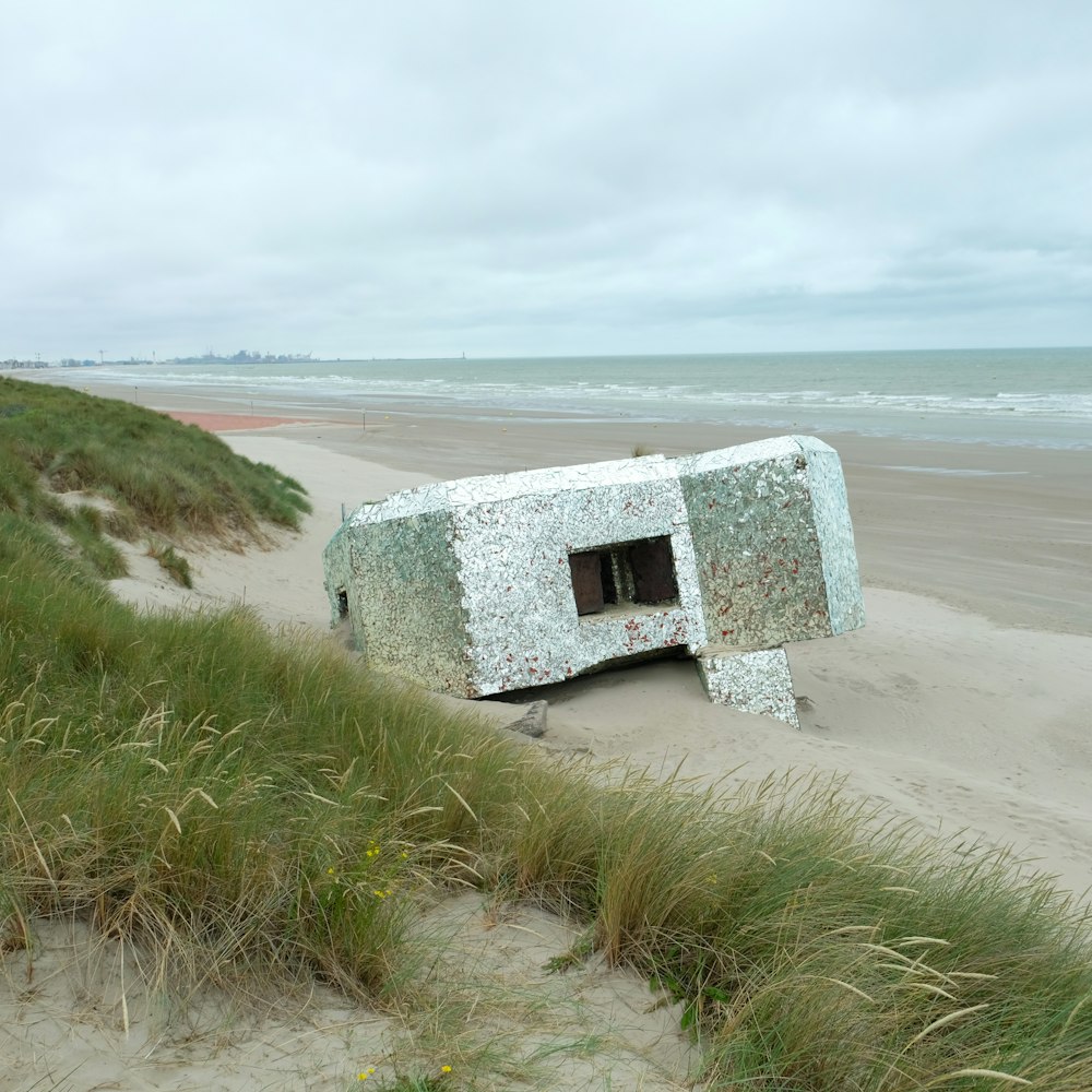 white and gray concrete house on seashore during daytime