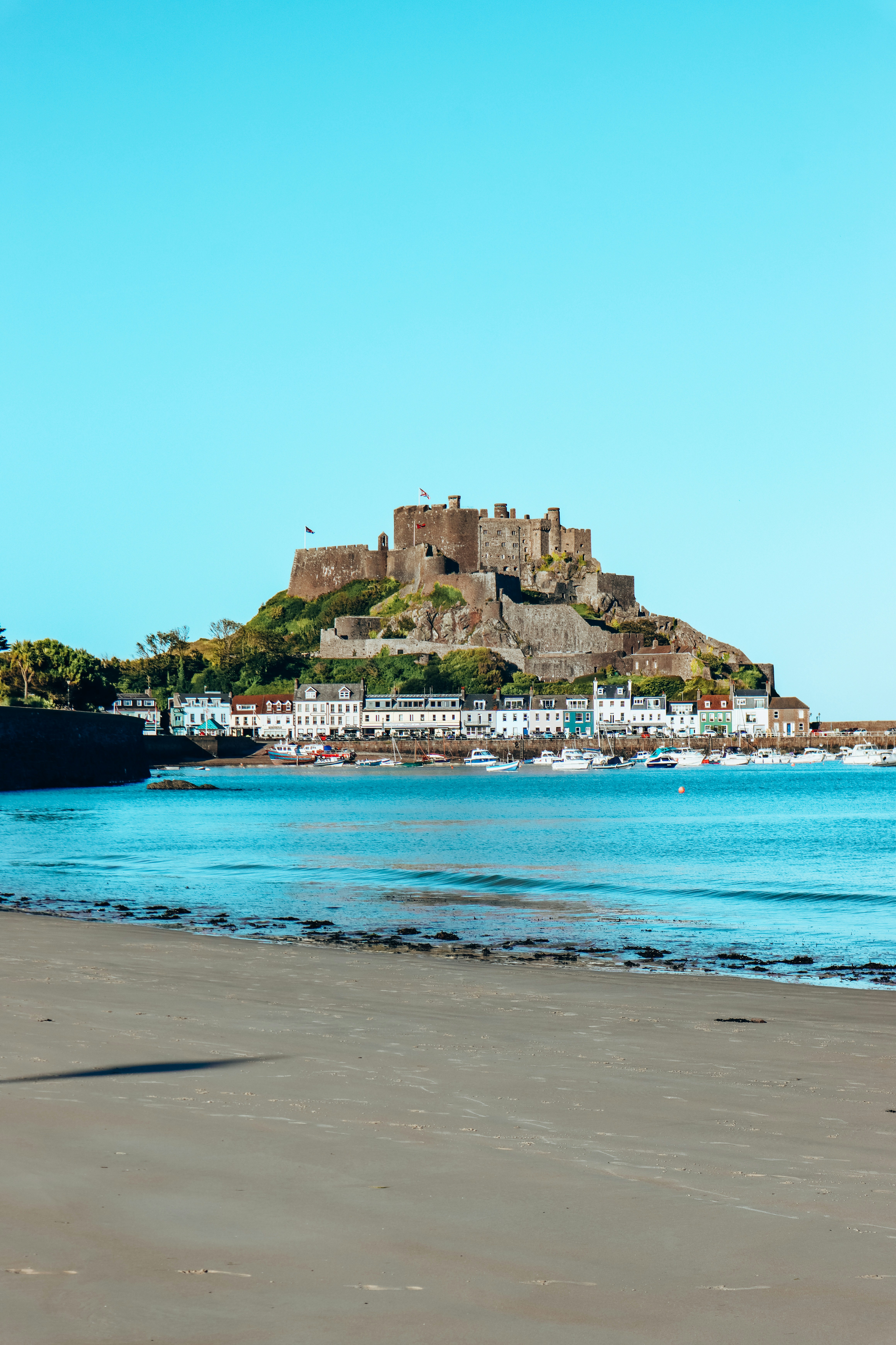 brown concrete building near sea during daytime