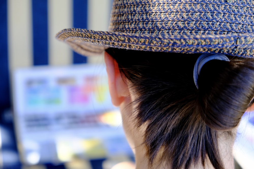 person wearing brown hat and black sunglasses