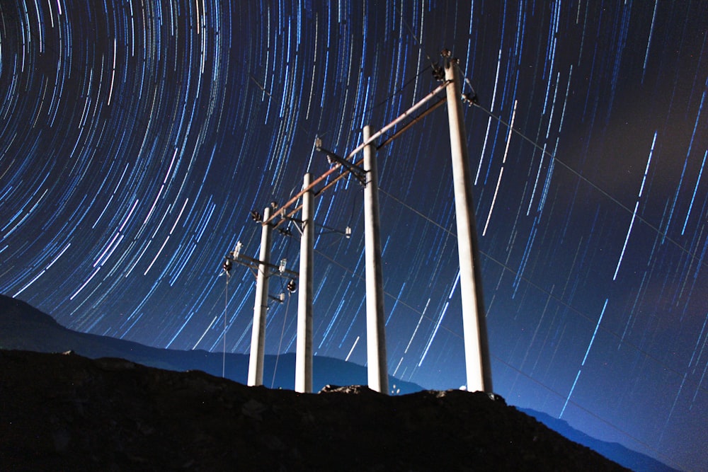 white wind turbines on hill during night time