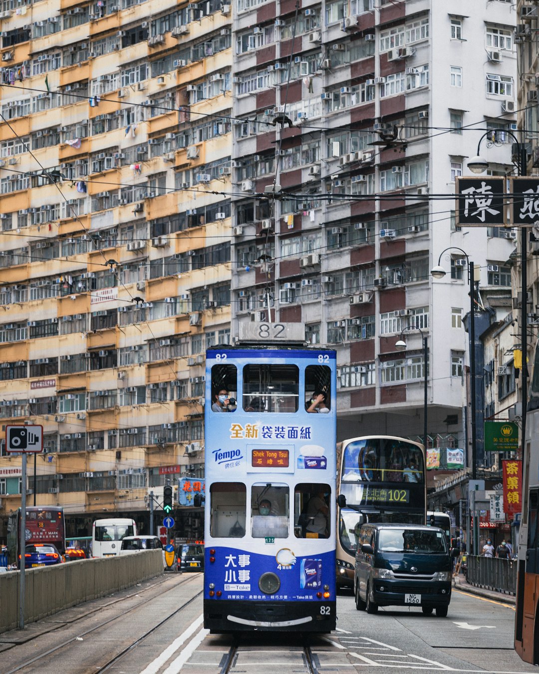 blue and white bus on road near high rise buildings during daytime