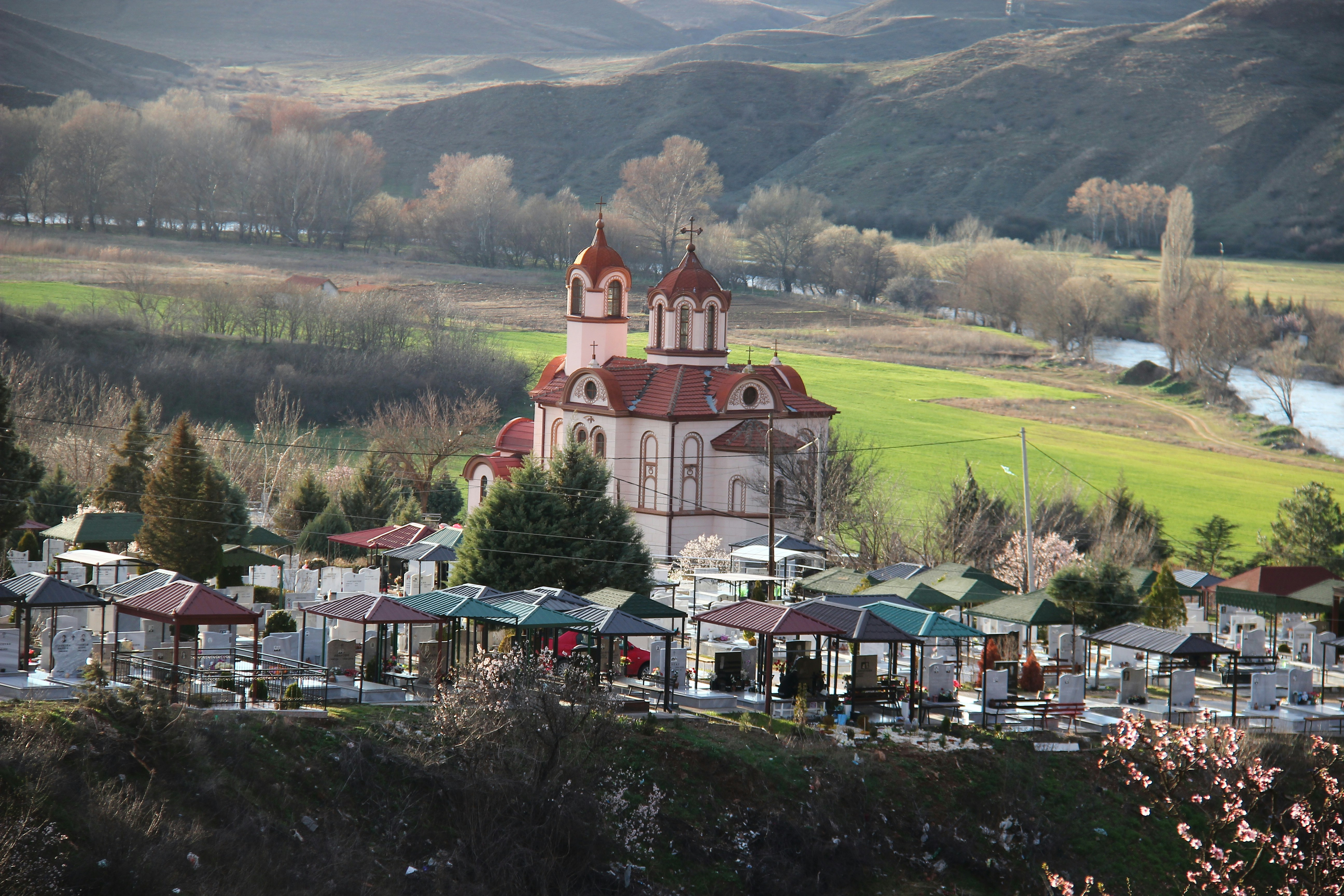 brown and white concrete building near green grass field during daytime