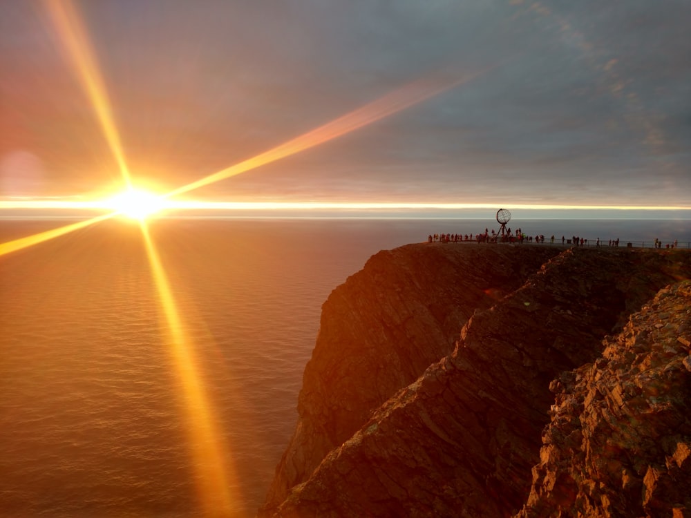 person standing on cliff during daytime