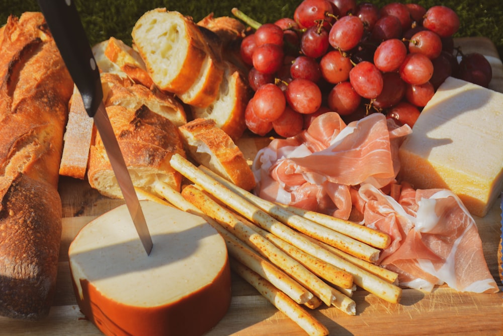 sliced bread and sliced tomato on brown wooden chopping board