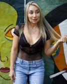 woman in black brassiere and blue denim shorts standing on boat