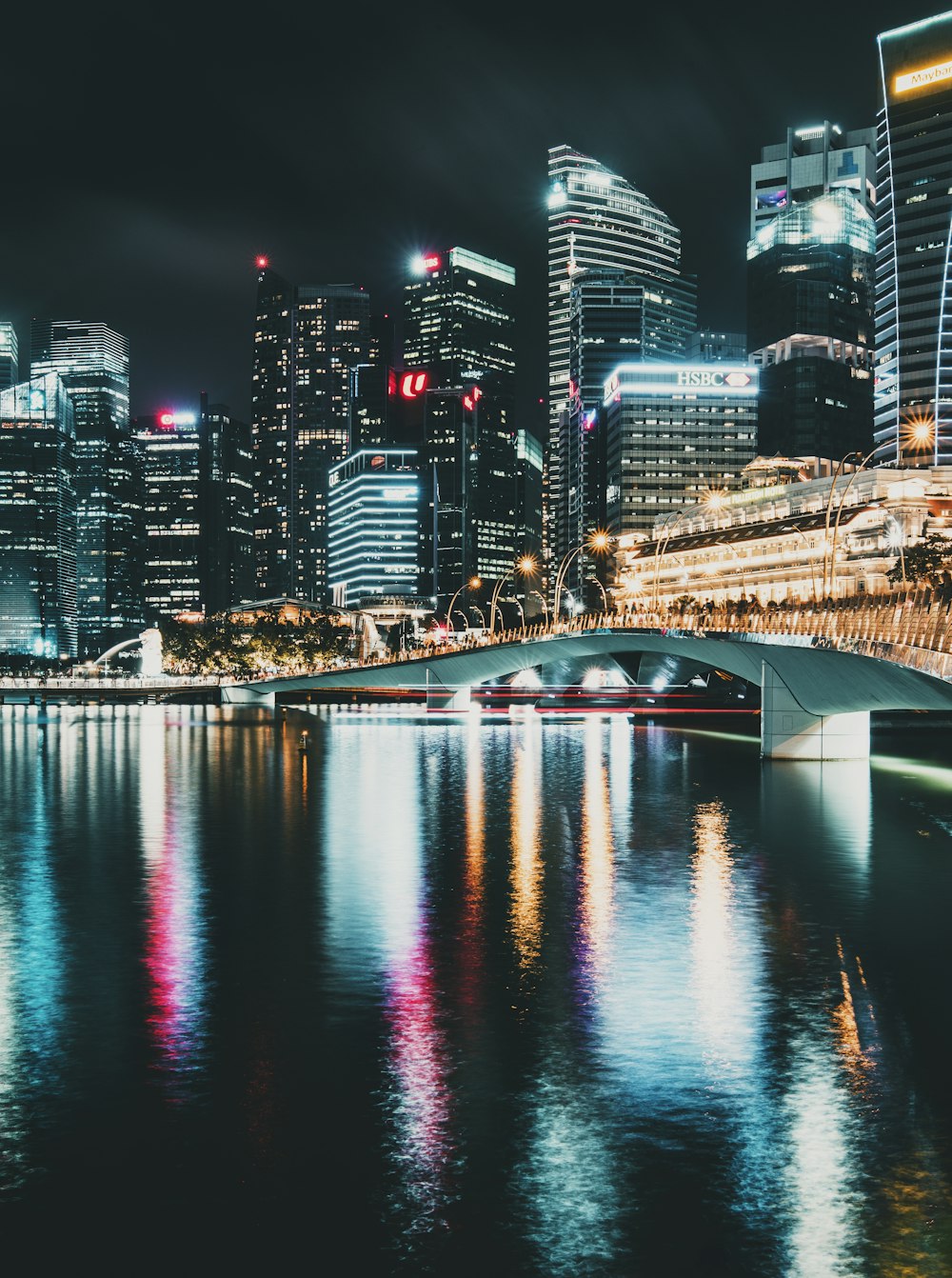 body of water near city buildings during night time