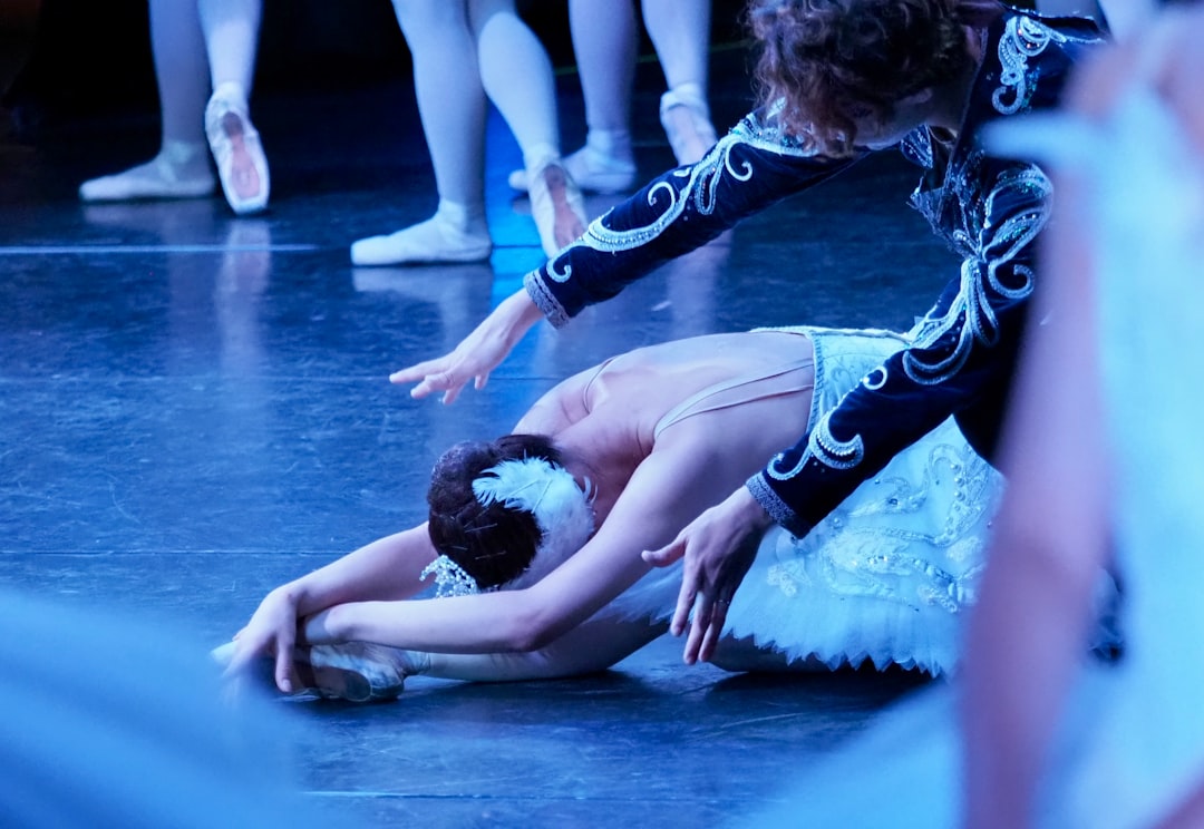 woman in black and white shorts lying on blue floor