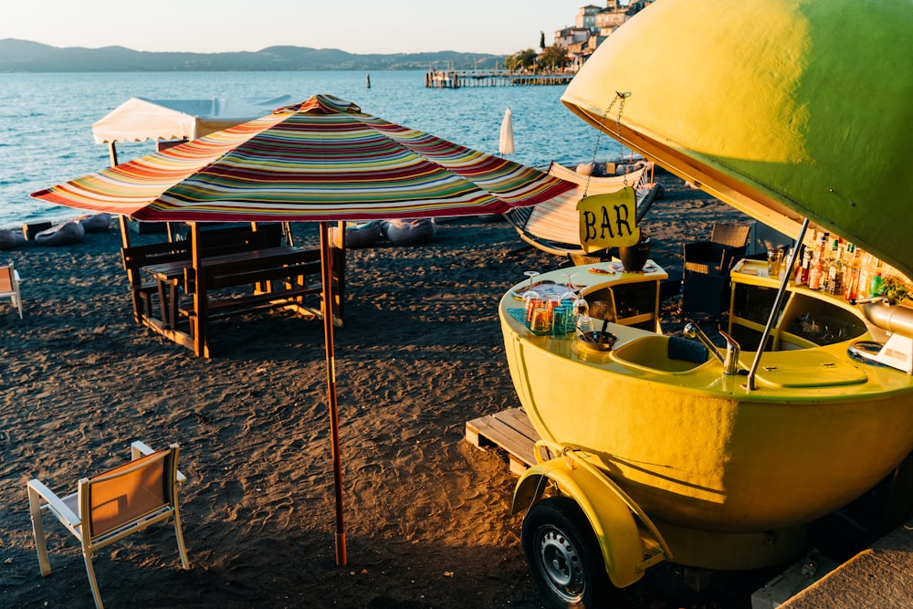 yellow and white boat on beach during daytime