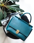 blue leather handbag on black leather bag