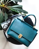 blue leather handbag on black leather bag