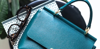 blue leather handbag on black leather bag