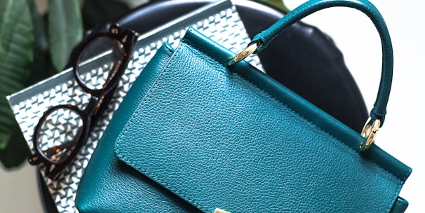 blue leather handbag on black leather bag