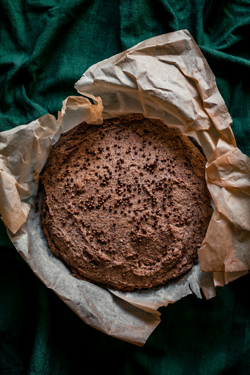 brown round bread on white paper