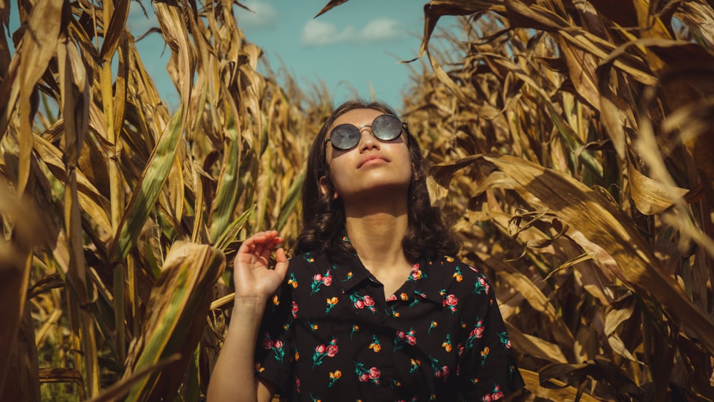 woman in black and red floral button up shirt wearing black sunglasses