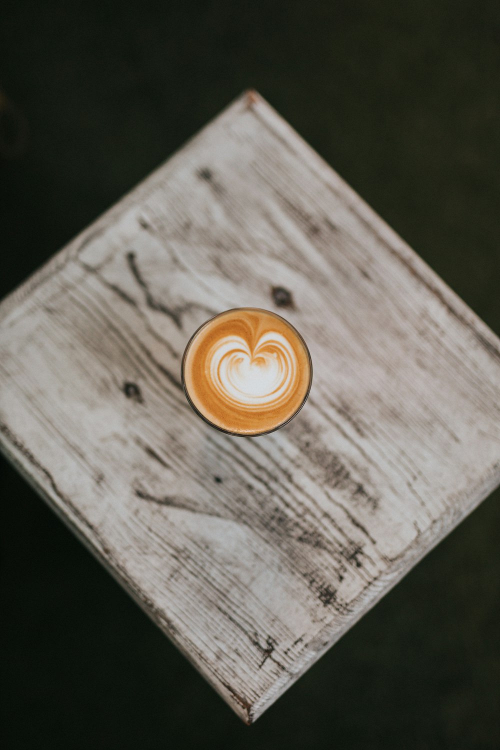 brown round plastic cup on brown wooden table