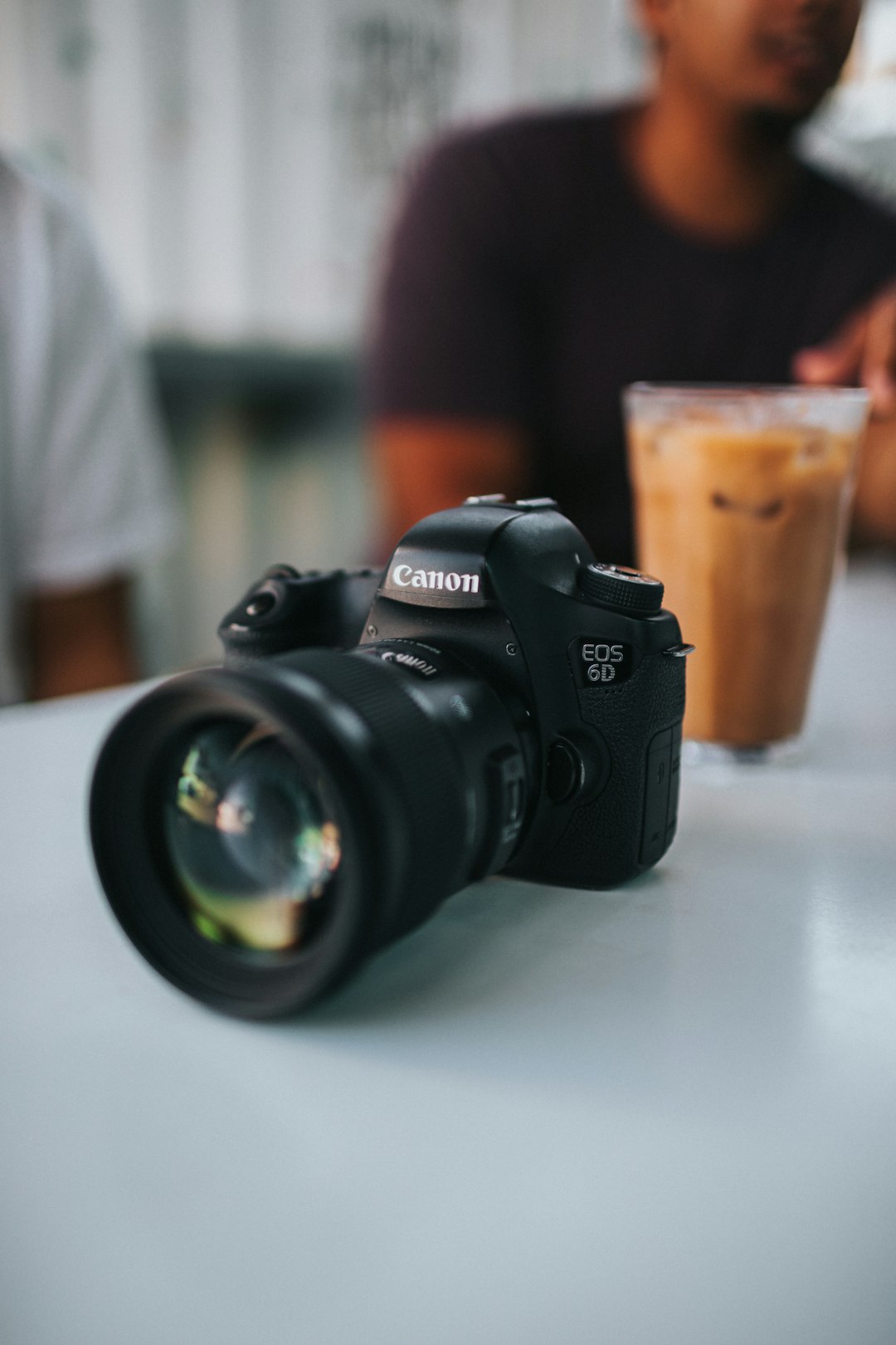 black nikon dslr camera on white table