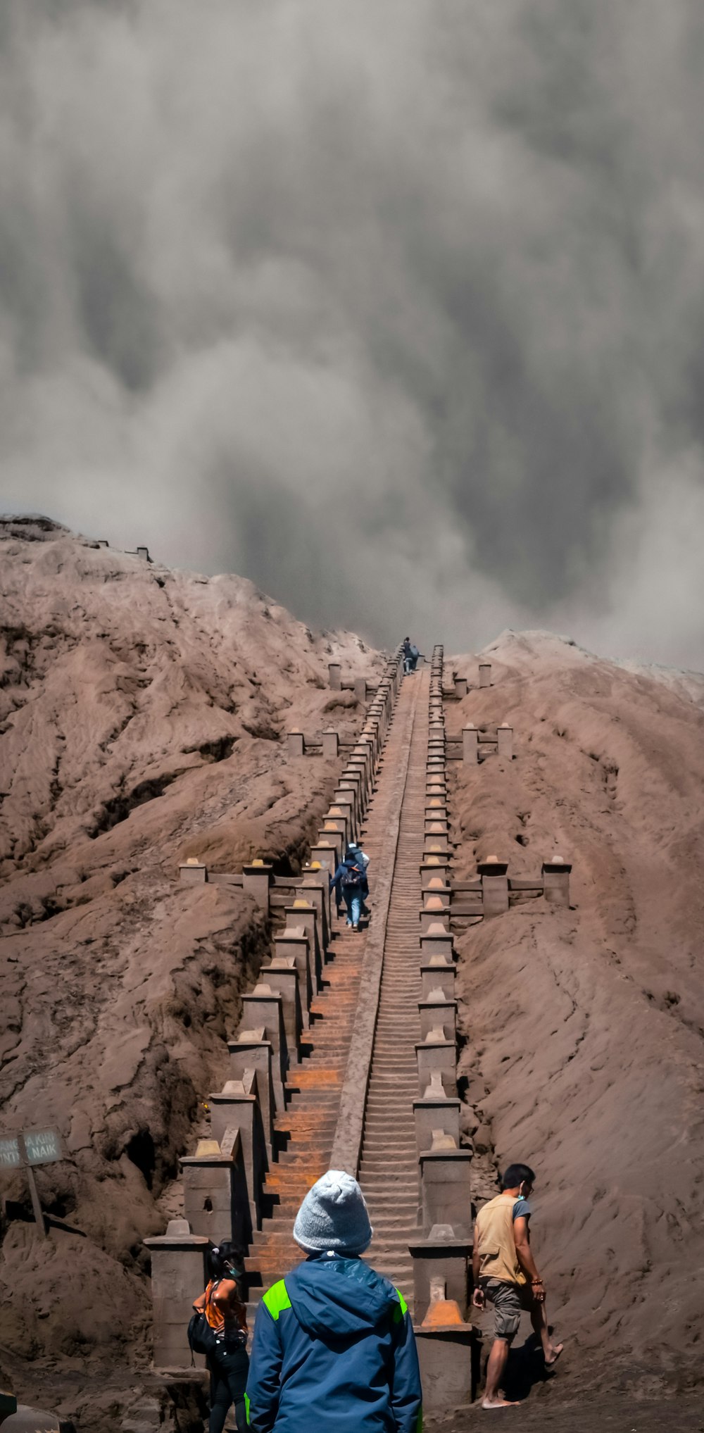 people walking on brown rocky mountain during daytime