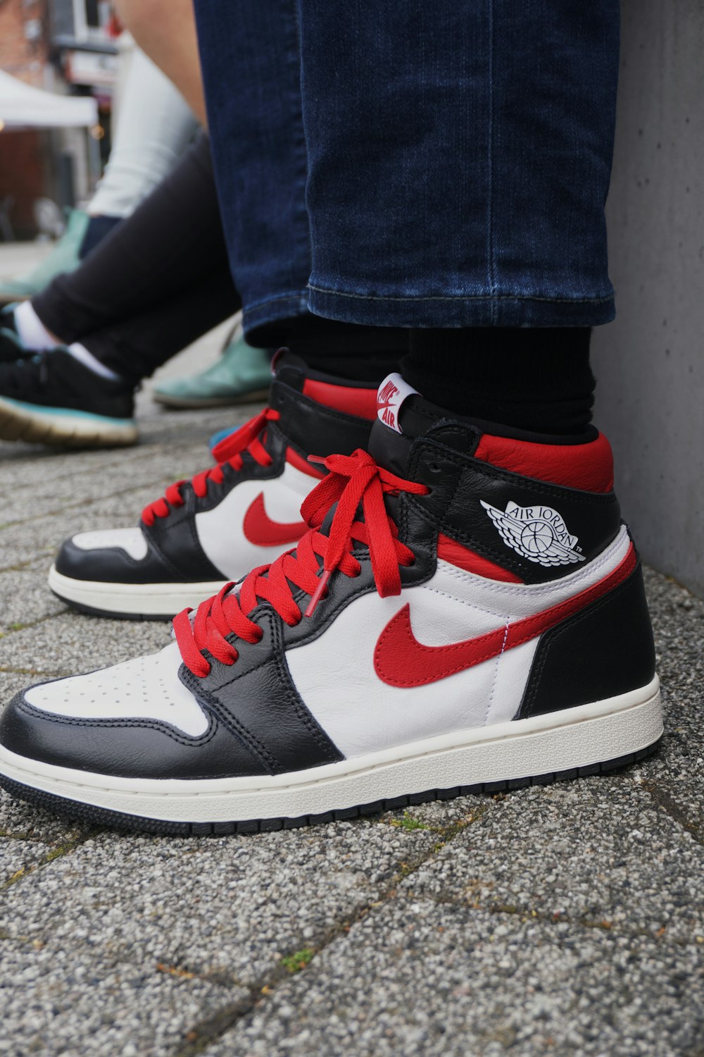 Person wearing black white and red nike air jordan 1 shoes photo – Free  Apparel Image on Unsplash