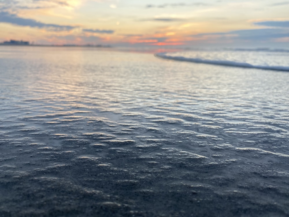 a body of water with a sky in the background