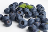 black round fruits on white table