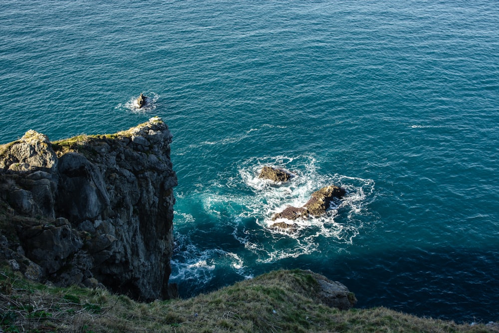 aerial view of rocky mountain beside sea during daytime