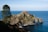 brown rock formation near body of water during daytime