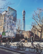 people riding bicycles on road near building during daytime