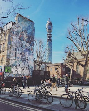 people riding bicycles on road near building during daytime