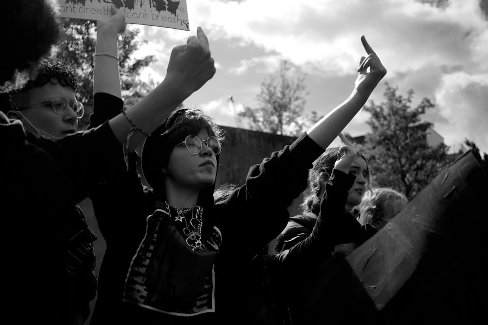 grayscale photo of woman in black long sleeve shirt holding white printer paper