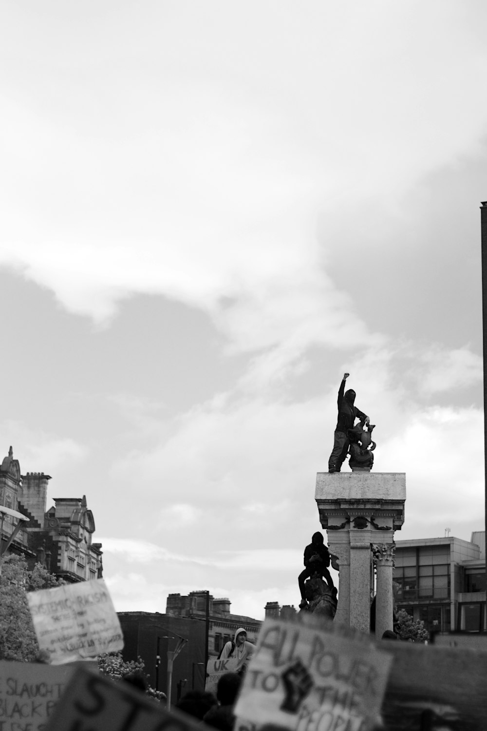 man riding horse statue under cloudy sky