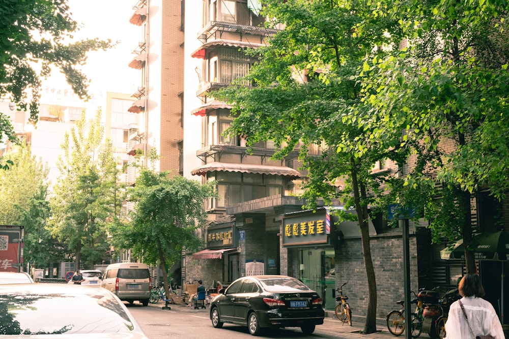 cars parked on side of the road near building during daytime