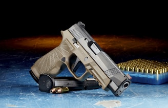 black and silver semi automatic pistol and bullets