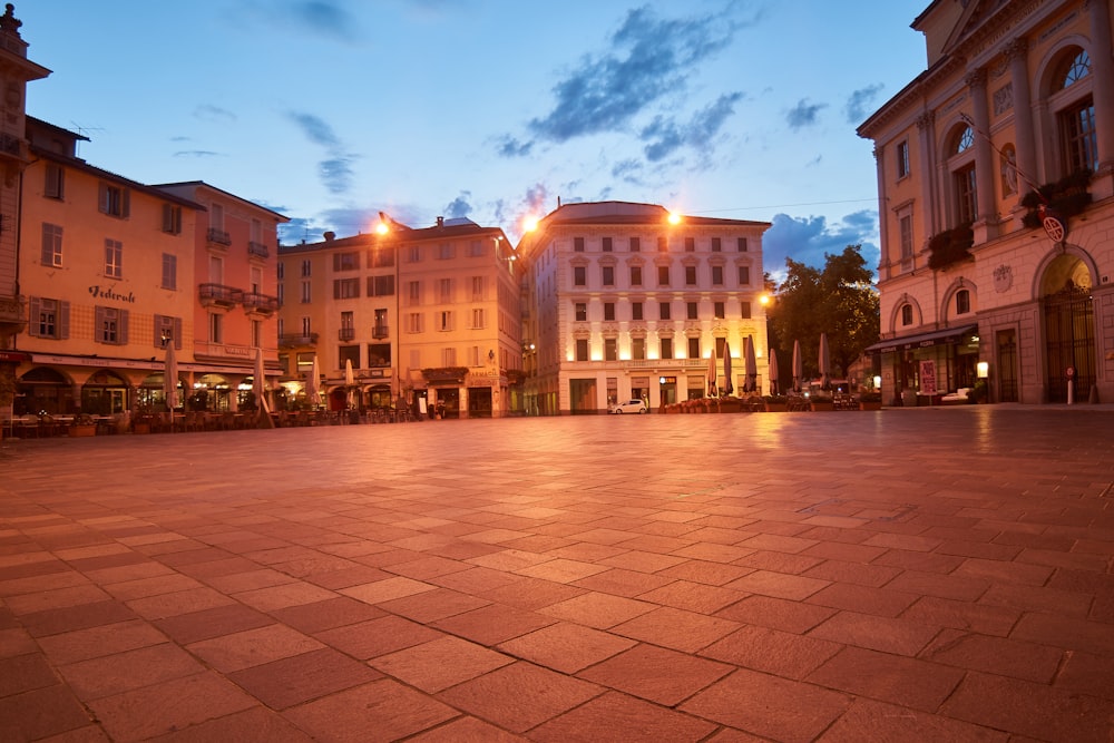 people walking on sidewalk near building during night time