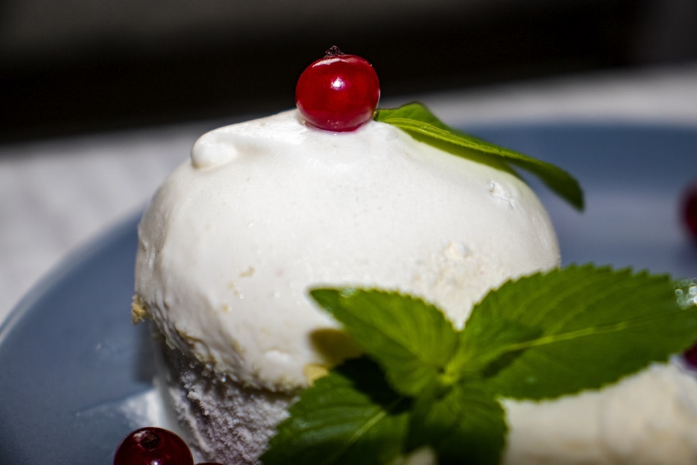 white ice cream with green leaf on top