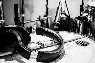 Alesis drum pads arranged neatly on a wooden floor with a pair of headphones nearby