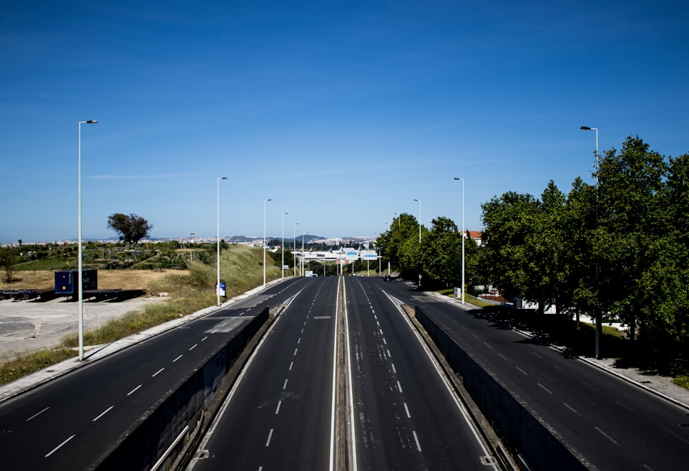 black asphalt road under blue sky during daytime