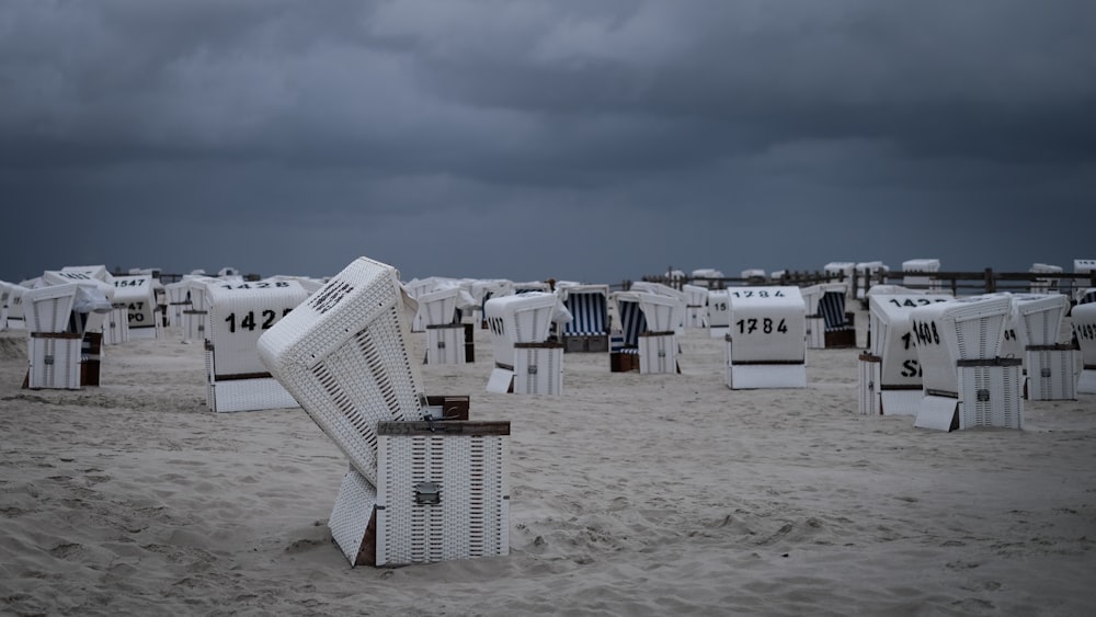 white wooden houses on white sand during daytime