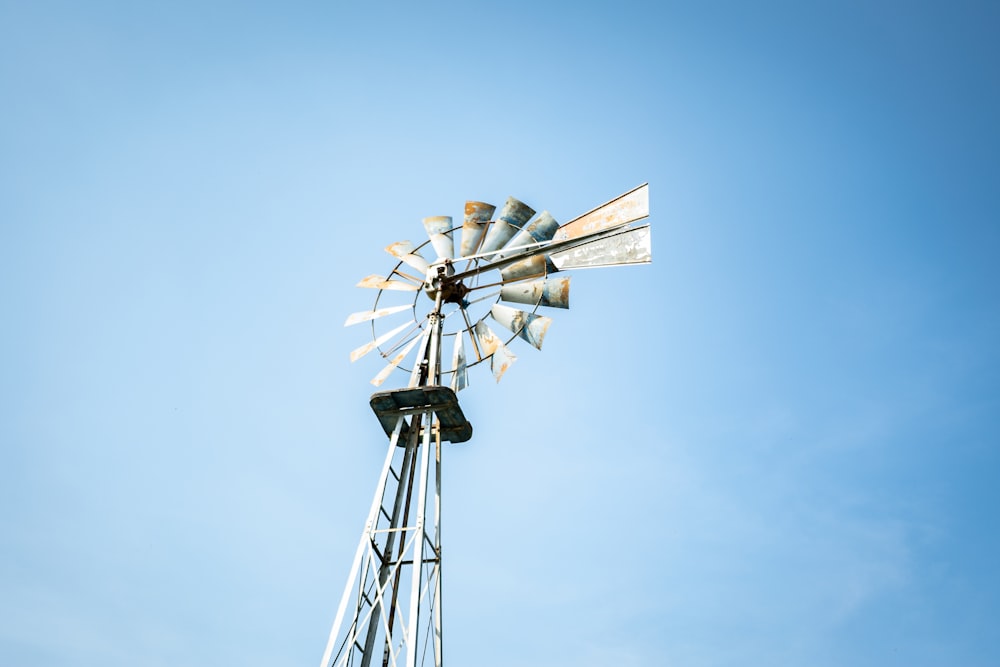 white wind mill under blue sky during daytime