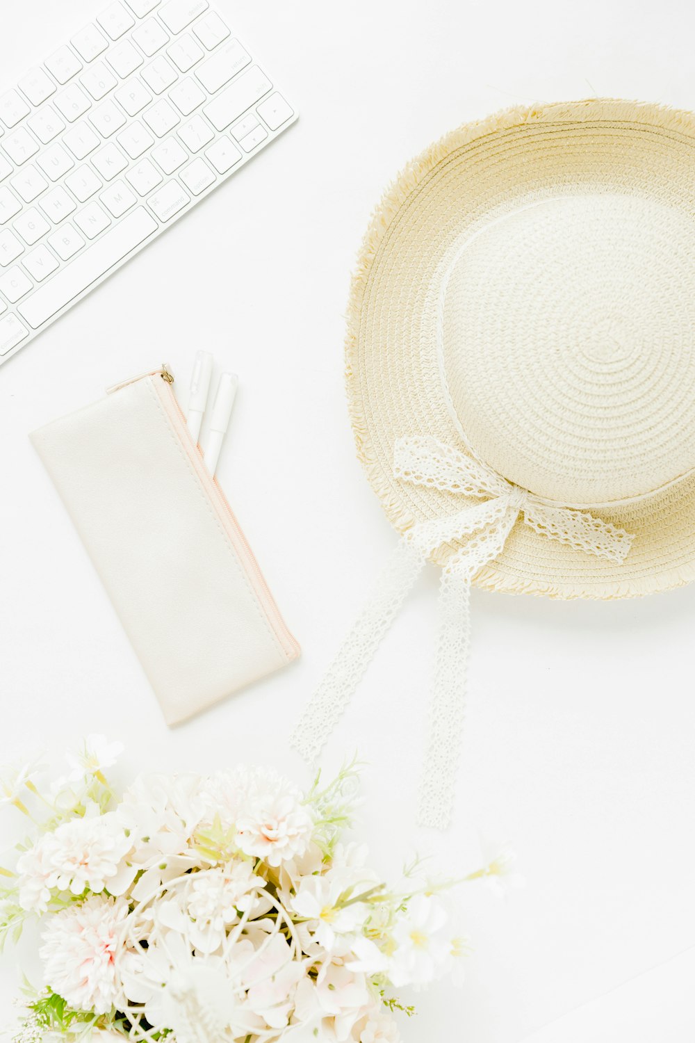 white leather pouch on white table