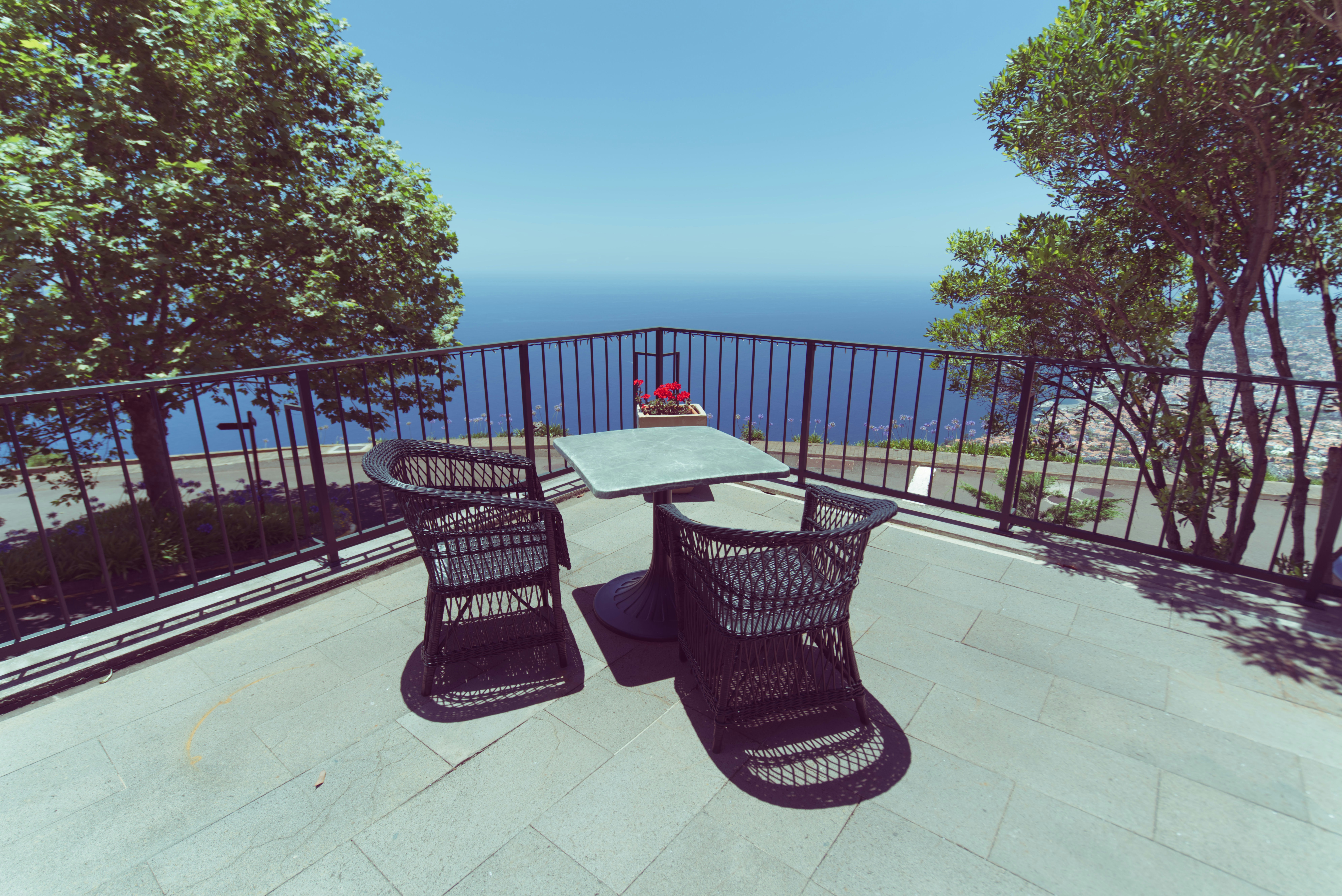 black metal table and chairs on gray concrete floor