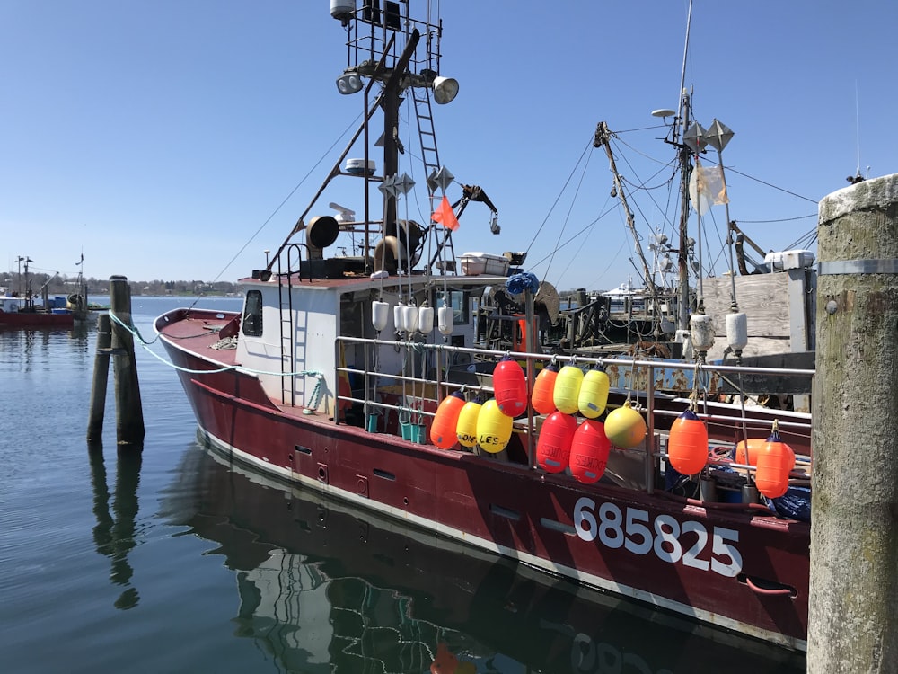 red and white boat on water during daytime