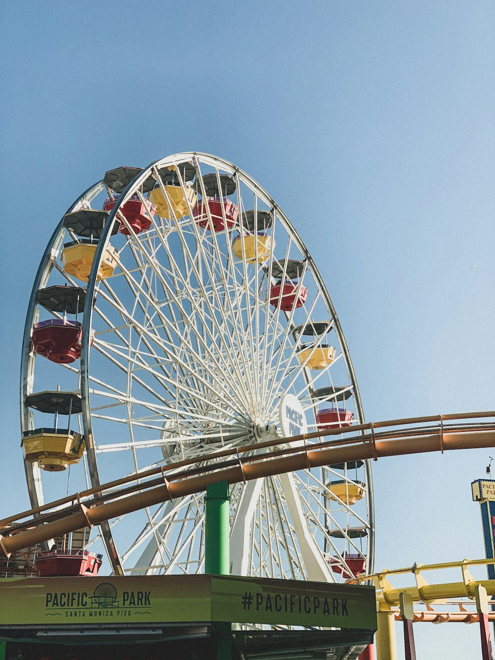 white and red ferris wheel under blue sky during daytime