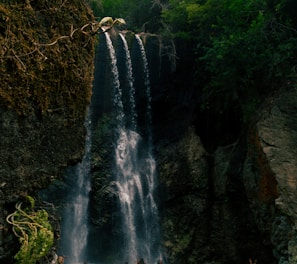 people standing near waterfalls during daytime
